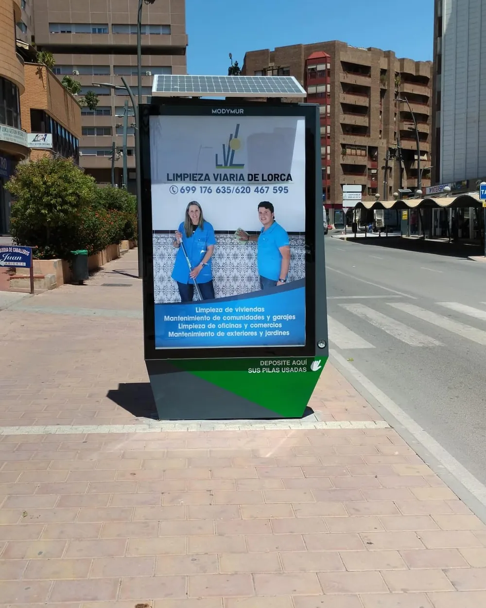 Marquesina de autobús en una calle de Lorca con el cartel de Limpieza Viaria de Lorca